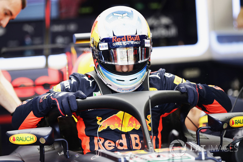 Daniel Ricciardo, Red Bull Racing RB13, climbs into his cockpit, fitted, a halo