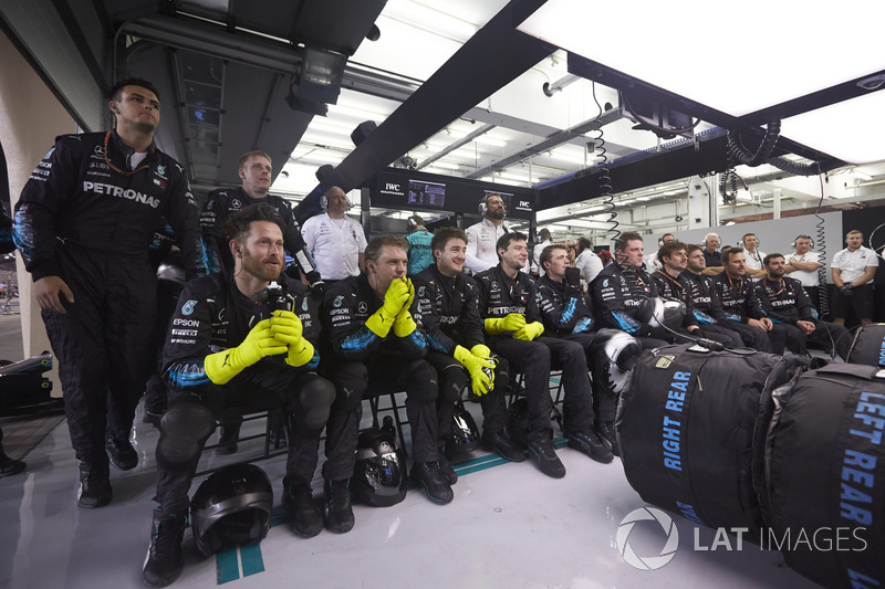 The Mercedes pit crew watch anxiously in the closing stages of the race