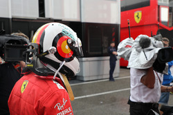 Sebastian Vettel, Ferrari walks in after crashing out of the lead of the race