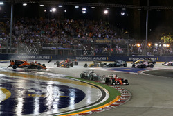 Sebastian Vettel, Ferrari SF70H leads at the start of the race as Fernando Alonso, McLaren MCL32, Kimi Raikkonen, Ferrari SF70H and Max Verstappen, Red Bull Racing RB13 crash in the background