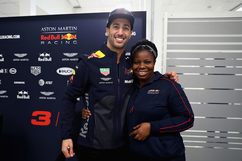 Daniel Ricciardo, Red Bull Racing poses for a photo with a Red Bull Racing team member