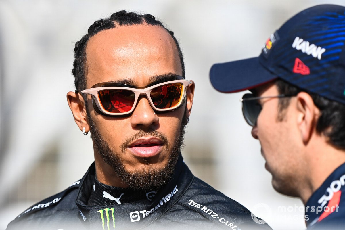 Lewis Hamilton, Mercedes-AMG, talks with Sergio Perez, Red Bull Racing