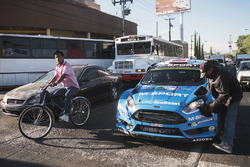 Mads Ostberg, Ola Floene, M-Sport Ford Fiesta WRC get a car wash at a stop light