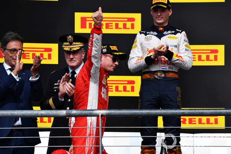 Race winner Kimi Raikkonen, Ferrari celebrates on the podium