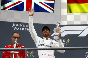Lewis Hamilton, Mercedes AMG F1, raises his second place trophy on the podium
