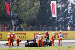 Romain Grosjean, Haas F1 Team VF-18, exits his damaged car after a lap one accident