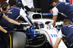 Lance Stroll, Williams Racing, is pushed into his pit by mechanics