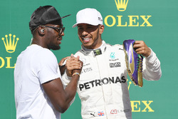 Race winner Lewis Hamilton, Mercedes AMG F1 celebrates on the podium with Usain Bolt