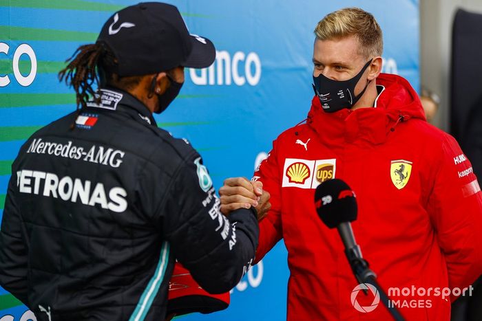 Mick Schumacher felicita a Lewis Hamilton, Mercedes-AMG F1, 1er puesto, por igualar el récord de victorias de su padre de 91 victorias y le regala el casco de su padre Michael Schumacher