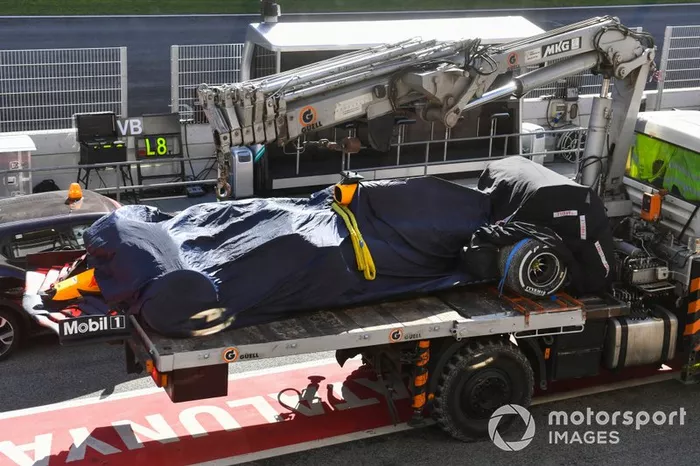 The Max Verstappen Red Bull Racing RB16 is returned to the pits on the back of a truck
