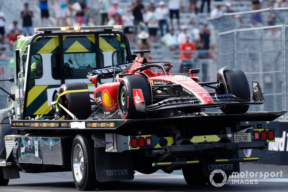 Collision-damaged Charles Leclerc Ferrari SF-23 sent back to pits on back of truck