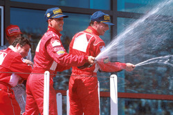 Podium: winner Michael Schumacher, Ferrari, second place Eddie Irvine, Ferrari, third place Mika Hakkinen, McLaren
