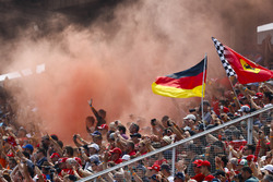 Fans in a grandstand set off flares