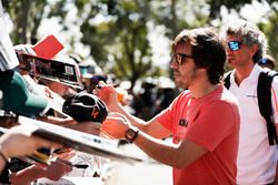 Fernando Alonso, McLaren, signs autographs for fans