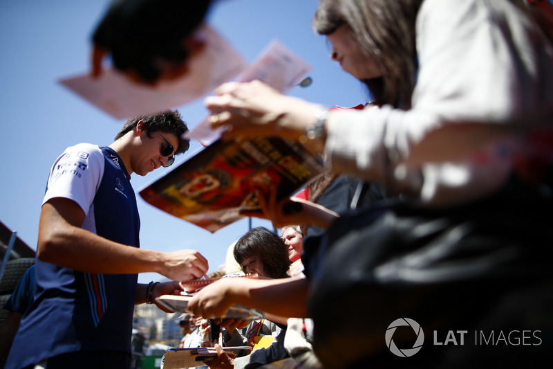 Lance Stroll, Williams Racing, signs autographs for fans