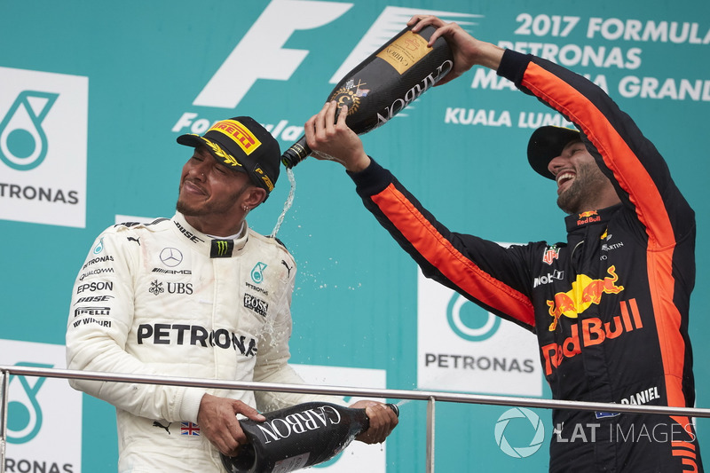 third place Daniel Ricciardo, Red Bull Racing, pours Champagne over second place Lewis Hamilton, Mercedes AMG F1