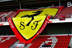 A large Ferrari banner in the grandstand