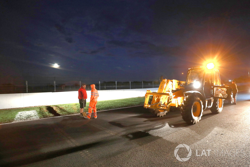 Crews work to improve drainage on the circuit before Sunday's race