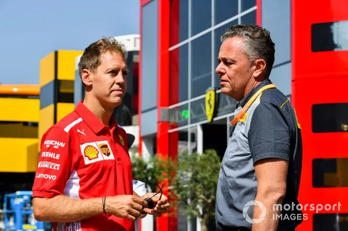 Sebastian Vettel, Ferrari, e Mario Isola, Racing Manager Pirelli Motorsport parlano nel paddock del Red Bull Ring
