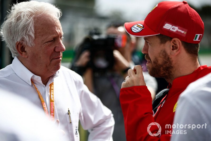 Charlie Whiting, Race Director, FIA, with Sebastian Vettel, Ferrari