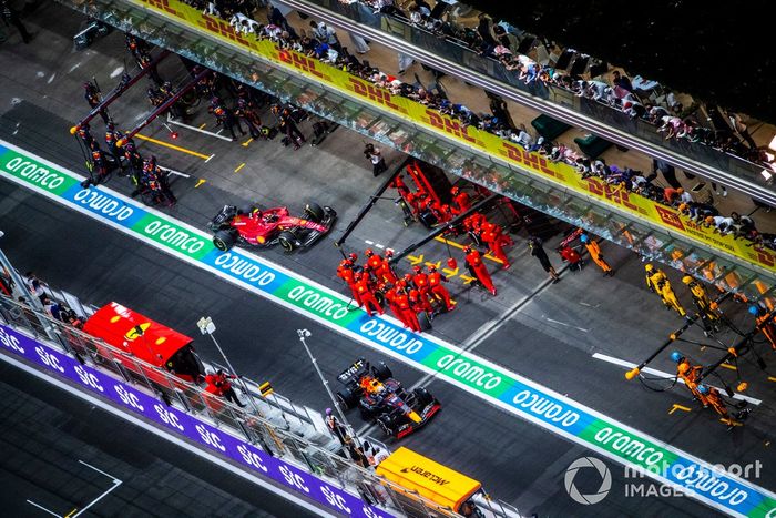 Max Verstappen, Red Bull Racing RB18, sale de boxes y Carlos Sainz Jr., Ferrari F1-75, para a hacer el pitstop