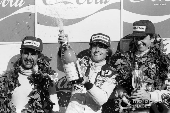 Podium: second place Carlos Reutemann, Lotus, Race winner  Jacques Laffite,  Ligier, third place  John Watson,  McLaren