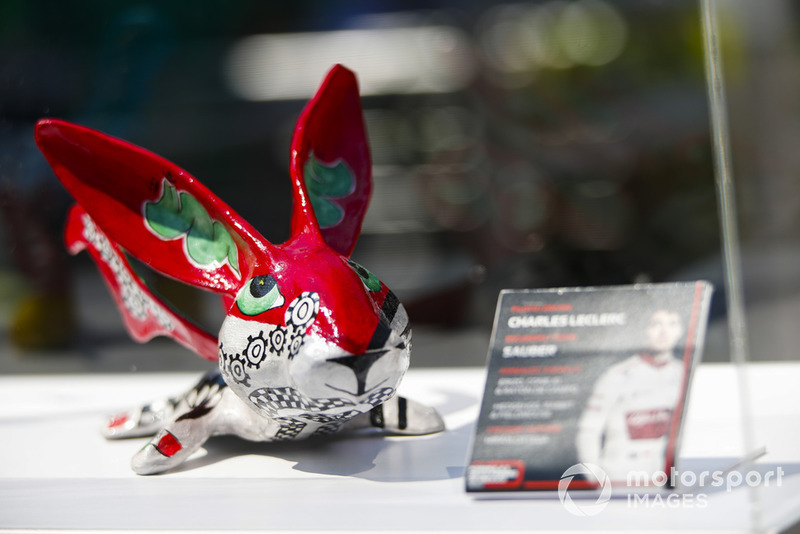 An Alebrijes sculpture on an autograph table for Charles Leclerc, Sauber