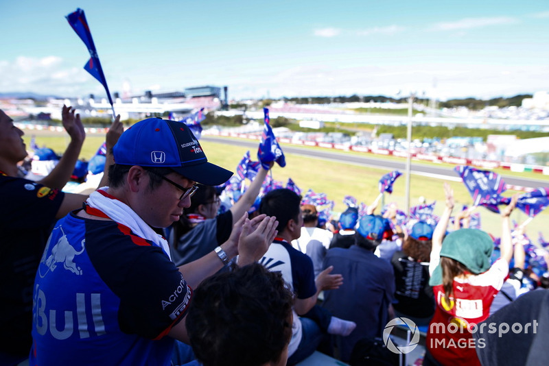 Fans with Toro Rosso flags await the start
