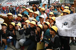 Lewis Hamilton, Mercedes AMG F1, meets some fans in the pit lane