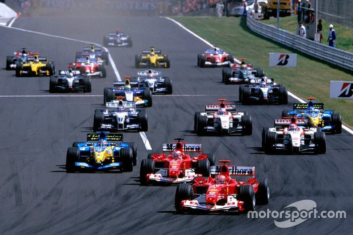 Michael Schumacher, Ferrari F2004 leads the field down to the first corner from the start