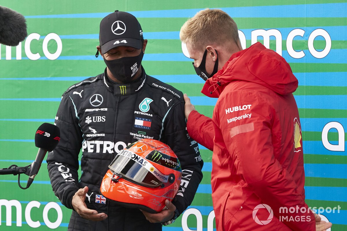 Mick Schumacher presents Lewis Hamilton, Mercedes-AMG F1, 1st position, with his fathers helmet after the Mercedes driver equalled Michael Schumachers record 91 race wins