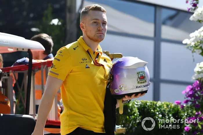 A member of the Renault team with Daniel Ricciardo's helmet