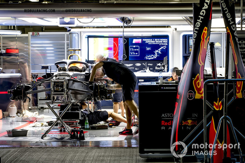 Engineers work on the car of Daniel Ricciardo, Red Bull Racing RB14, in the garage