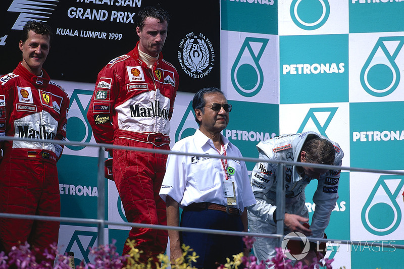 Podium: Race winner Eddie Irvine, Ferrari, second place Michael Schumacher, Ferrari, third place Mik