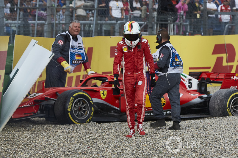 Sebastian Vettel, Ferrari SF71H, walks away from his car after crashing out from the lead