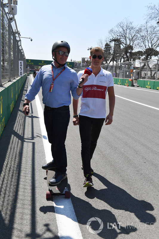 Marcus Ericsson, Sauber walks the track and talks with Johnny Herbert, Sky TV on a skateboard