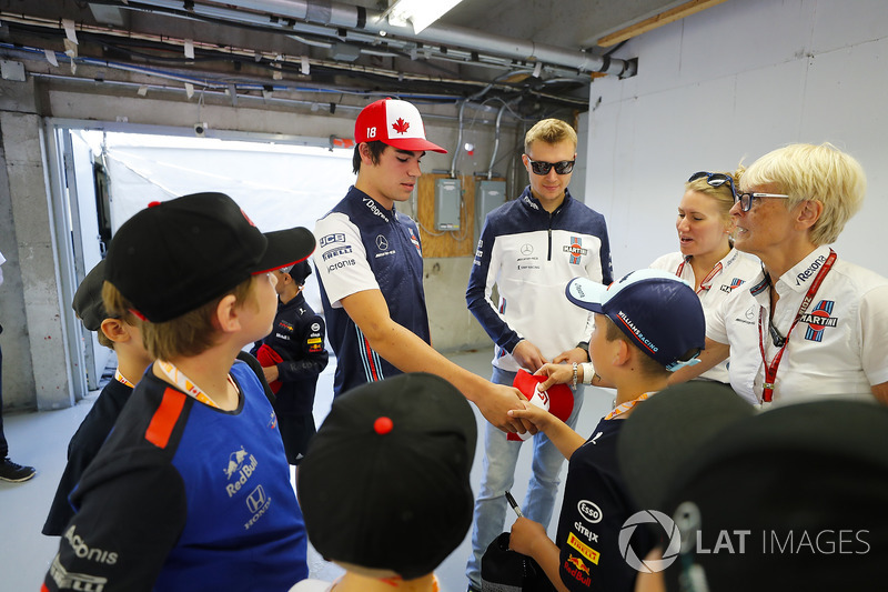 Lance Stroll, Williams Racing, and Sergey Sirotkin, Williams Racing, meet grid kids as PR Anne Brads