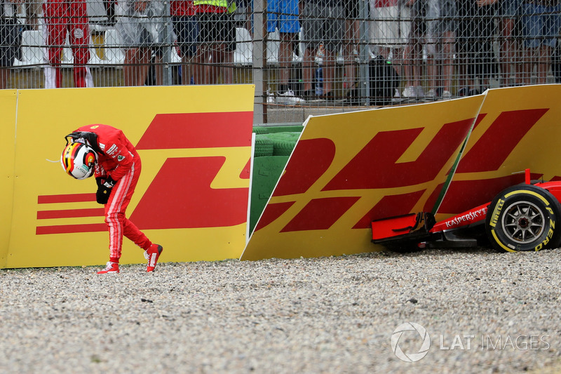 Sebastian Vettel, Ferrari SF71H walks in after crashing out of the race