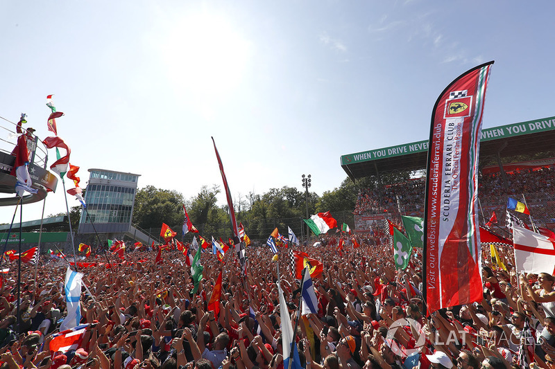 Streamers fall as the top three drivers celebrate on the podium, Champagne