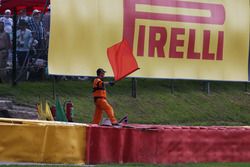 A marshal waves a red flag as the race is stoppd