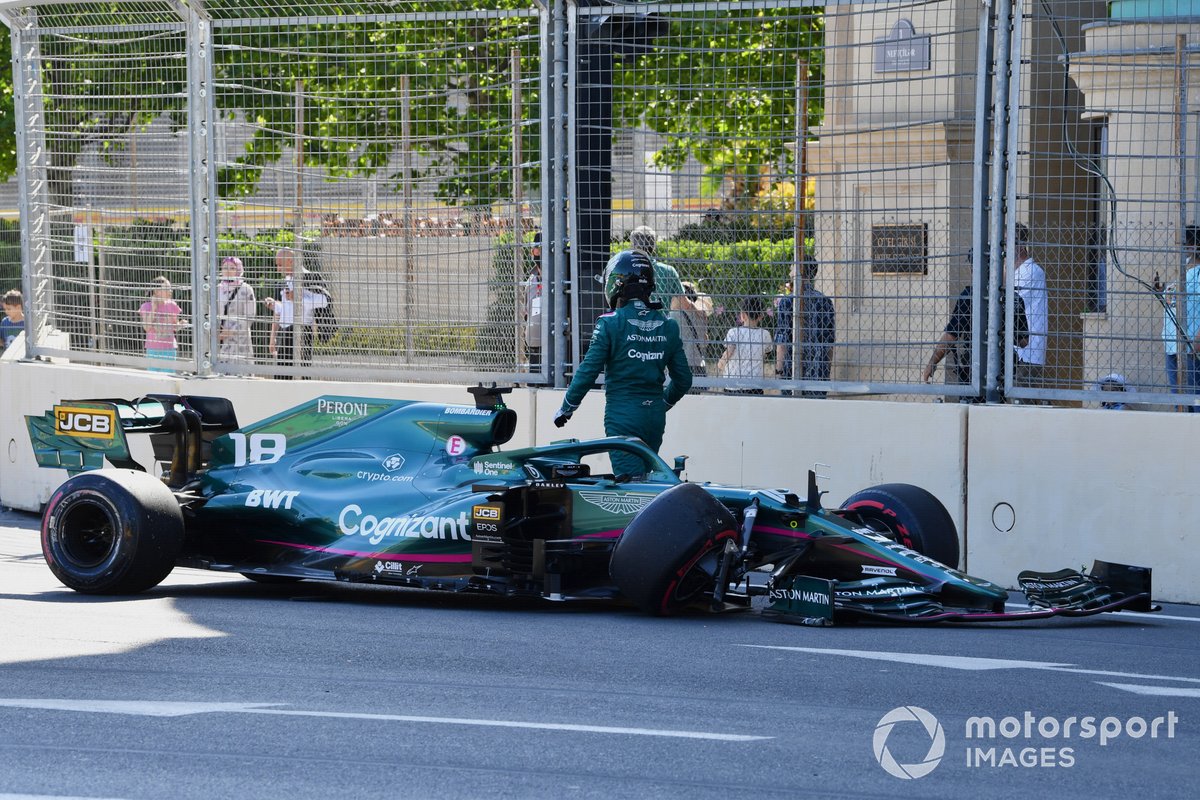 Lance Stroll, Aston Martin AMR21, walks away from his car after hitting the wall