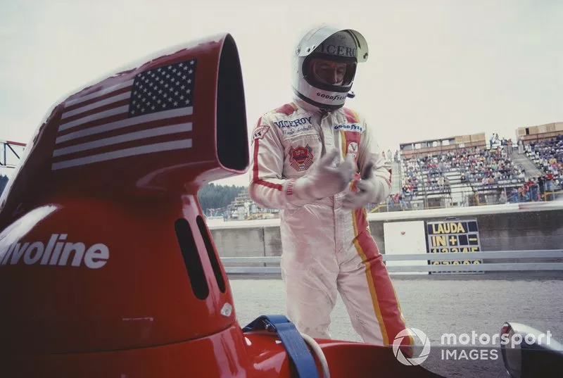 Mario Andretti stands next to his Parnelli VPJ4B Ford in the pits