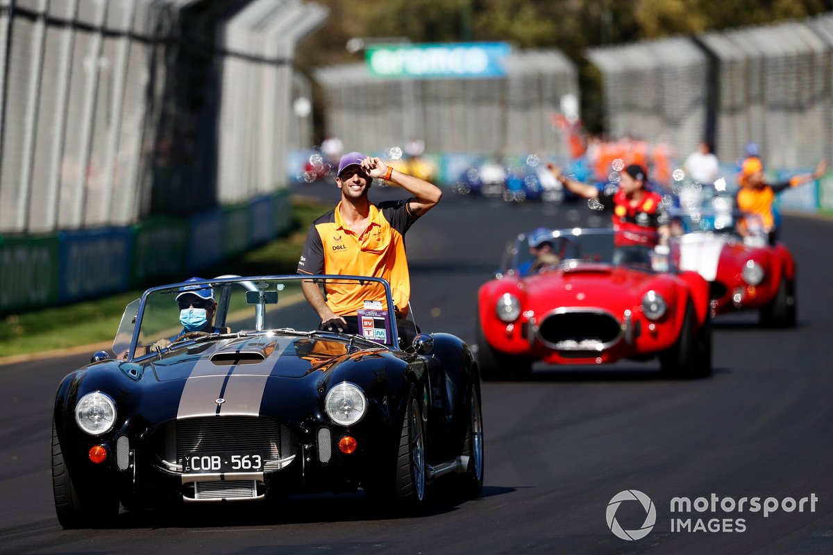 Daniel Ricciardo, McLaren MCL36, rides in an AC Cobra