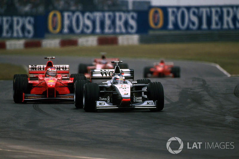 Mika Hakkinen, McLaren Mercedes MP4/13 leads Michael Schumacher, Ferrari F300