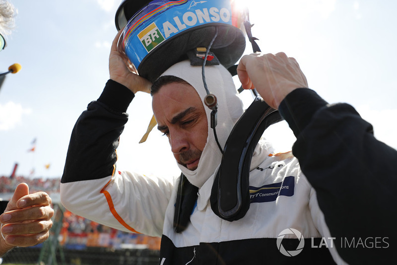 Fernando Alonso, McLaren, takes his helmet off on the grid