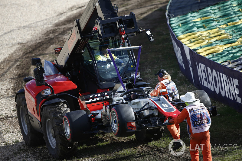 Marshals remove the car of Romain Grosjean, Haas F1 Team VF-18 Ferrari, from the circuit