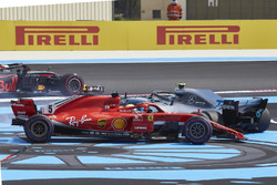 Sebastian Vettel, Ferrari SF71H, and Valtteri Bottas, Mercedes AMG F1 W09, spin to the back after contact on the opening lap
