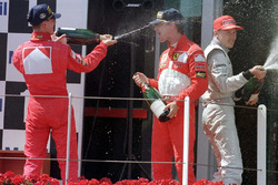 Podium: race winner Michael Schumacher, Ferrari, second place Eddie Irvine, Ferrari, third place Mika Hakkinen, McLaren