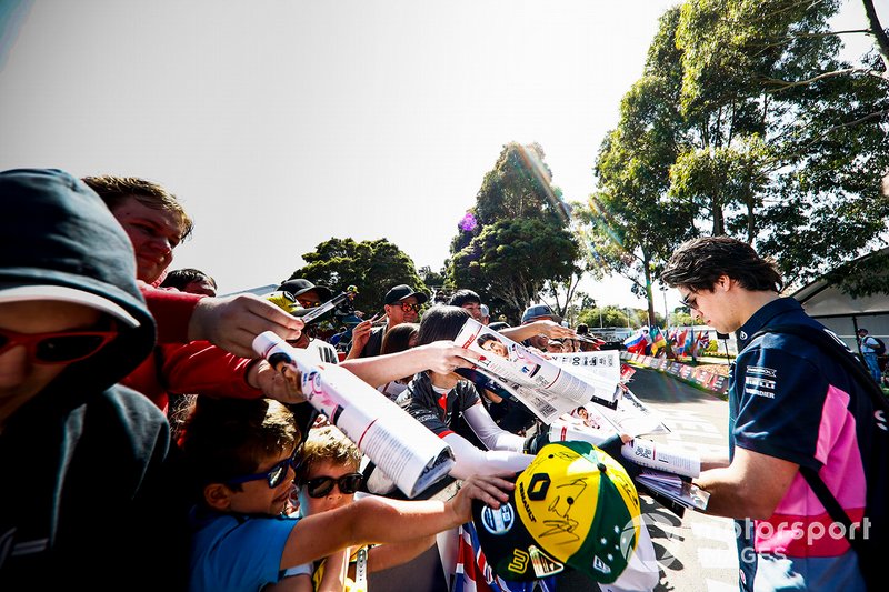 Lance Stroll, Racing Point hand signs autographs for fans