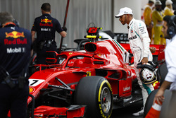 Lewis Hamilton, Mercedes AMG F1, studies the Kimi Raikkonen, Ferrari, after qualifying